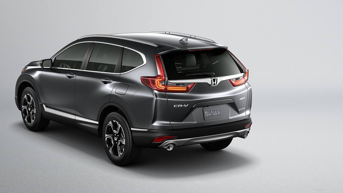 Rear 3/4 view of 2019 Honda CR-V Touring in Gunmetal Metallic showing LED taillights.