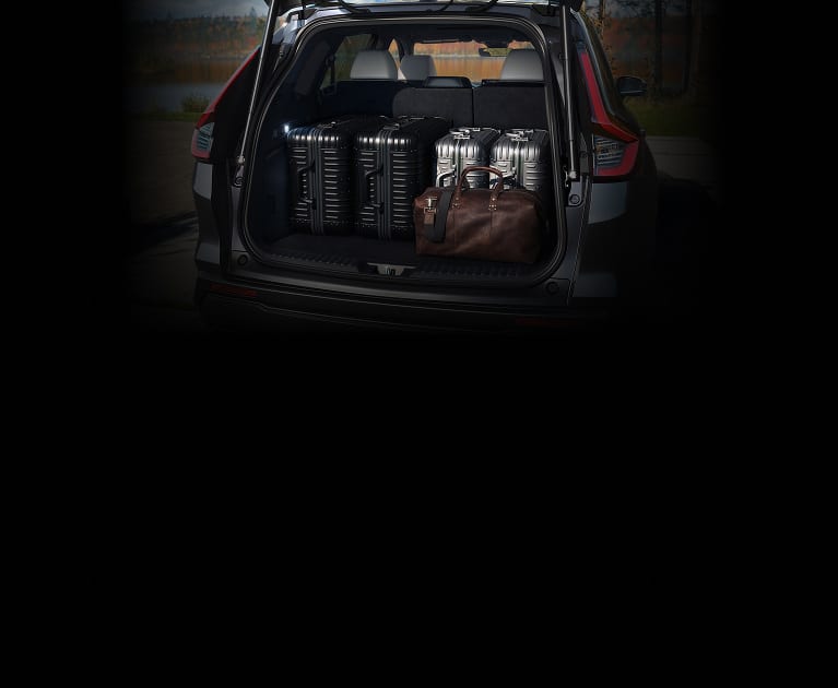 2027 Honda CR-V Sport Touring Hybrid cargo area filled with multiple suitcases (Compact Crossover SUV).