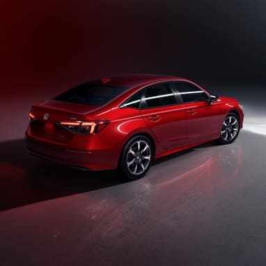 2027 Honda Civic Sedan Sport Touring Hybrid in Rallye Red rear three-quarter view in a studio (Compact Sedan)