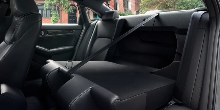 2027 Honda Civic Sedan Sport Touring Hybrid rear seats folded down showing trunk pass-through (Compact Sedan)